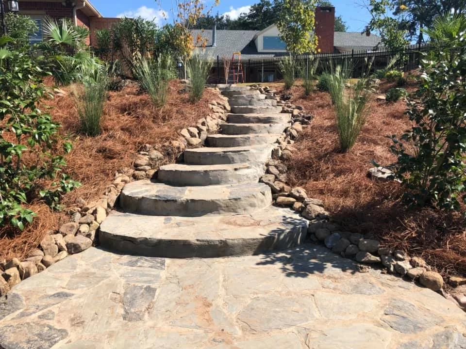 Natural stone steps climbing a planted hillside