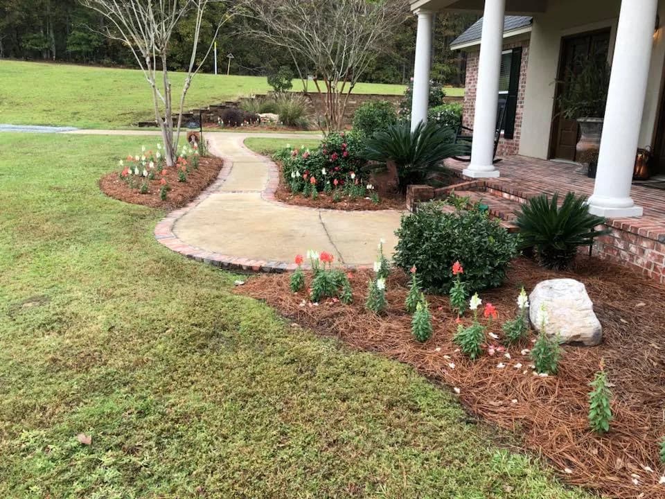 Curved walkway with colorful planting beds